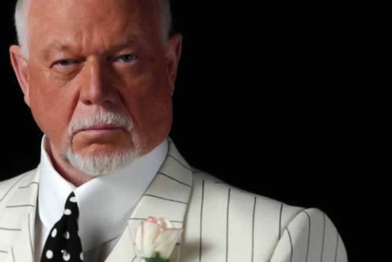 An image of Don Cherry wearing a white polkadot tie, whiite high collar shirt and a white jacket with thin black pinstripe